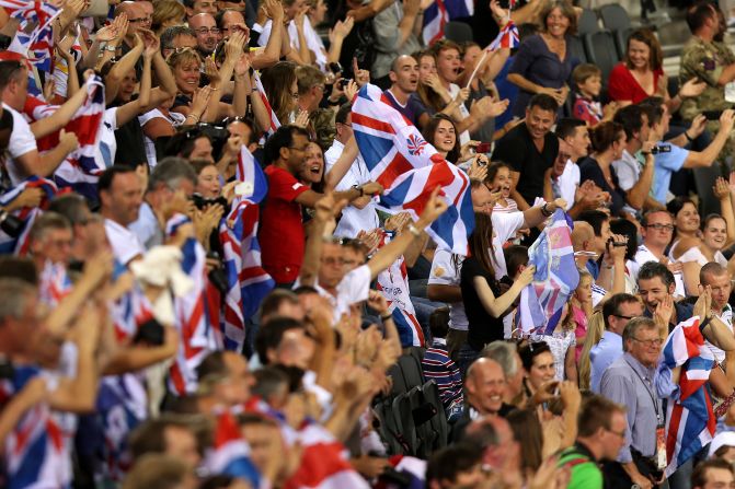 Spectators cheer from the stands during track cycling events at London Velopark in east London.