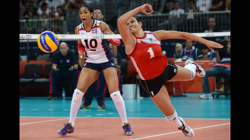 Algeria's Sehryne Hennaoui, right, dives for a shot during the women's preliminary pool volleyball match against the Dominican Republic.