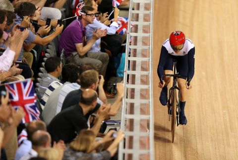 Spectators cheer on Victoria Pendleton of Great Britain during a women's sprint track cycling qualifier.