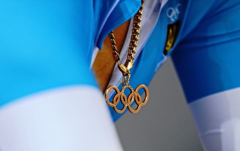 Lyubov Sulika of Ukraine wears an Olympic rings pendant as she prepares for a women's sprint qualifying track cycling event.
