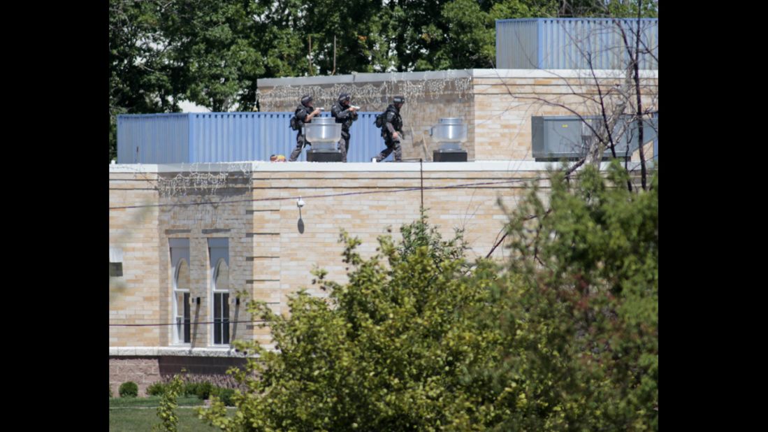 SWAT officers surround a Sikh temple in Oak Creek, Wisconsin, where a gunman whom authorities identified as Wade Michael Page, 40, stormed the building and opened fire on August 5. The incident left six people and the gunman dead.