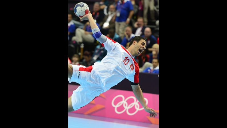 Tunisian centerback Kamel Alouini shoots during the men's preliminary Group A handball match against Argentina on Monday.