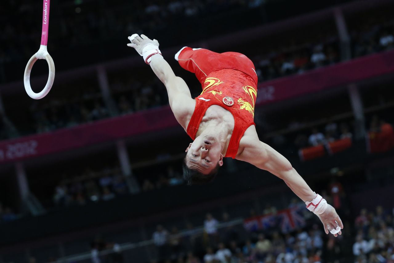 Chen Yibing of China dismounts to win the silver medal in the men's rings final.