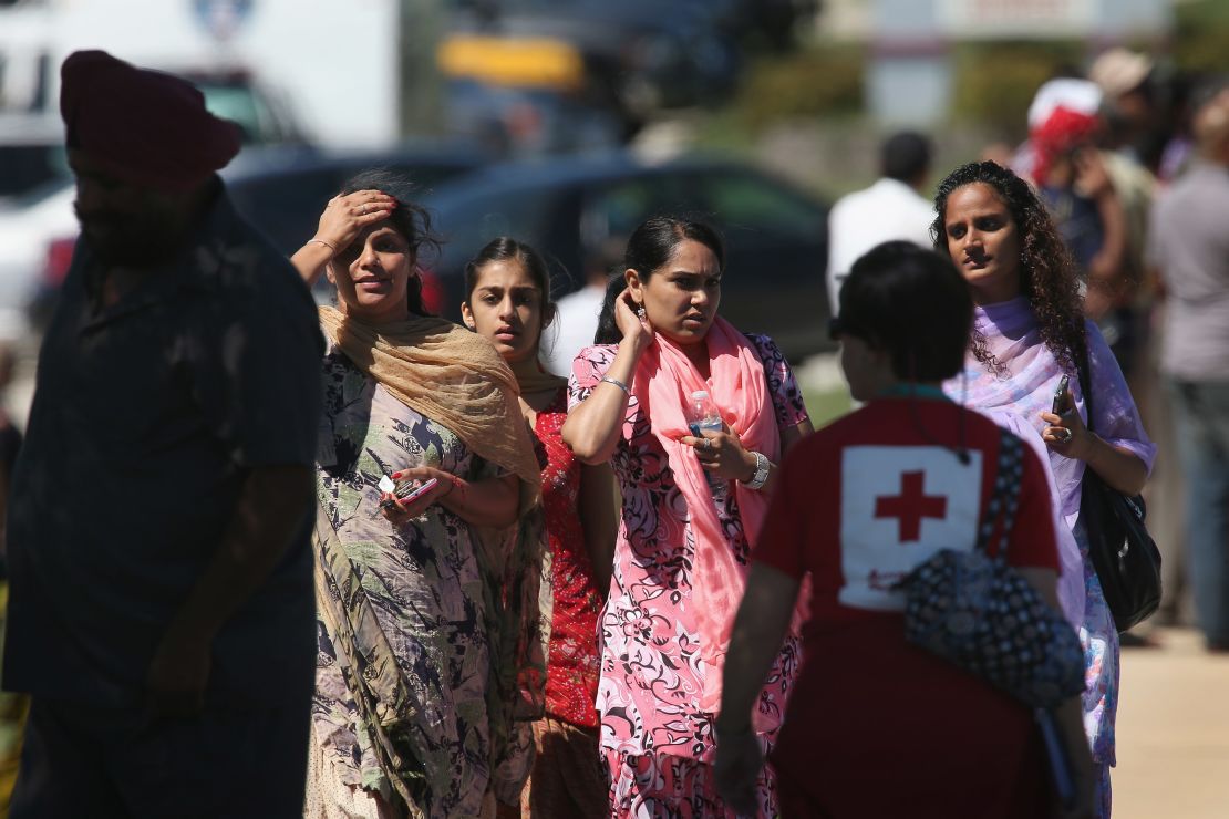 People look on at a Sikh temple in Oak Creek, Wisconsin, where a gunman killed six people at a service Sunday.