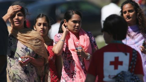 People look on at a Sikh temple in Oak Creek, Wisconsin, where a gunman killed six people at a service Sunday.