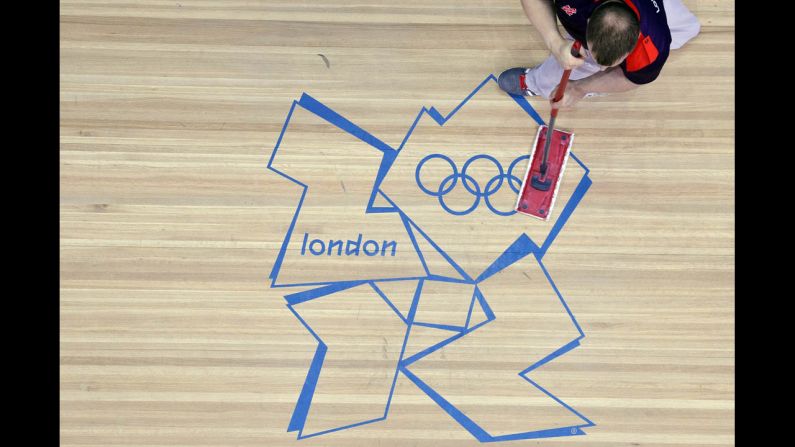 The stage is cleaned before the men's 105-kilogram Group B weightlifting event at the Excel Centre in London.