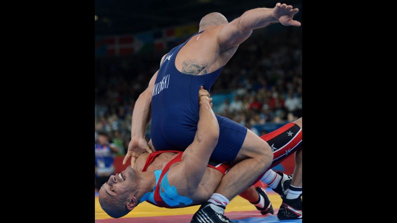 Egypt's Karam Mohamed Gaber Ebrahim, bottom, wrestles Poland's Damian Janiskowski during the men's Greco-Roman 84-kilogram semifinal.