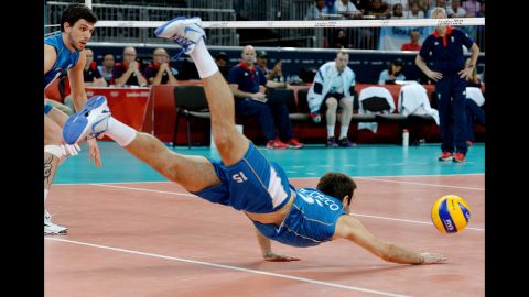 Argentina's Luciano de Cecco dives for a ball during the men's preliminary volleyball match with Great Britain.