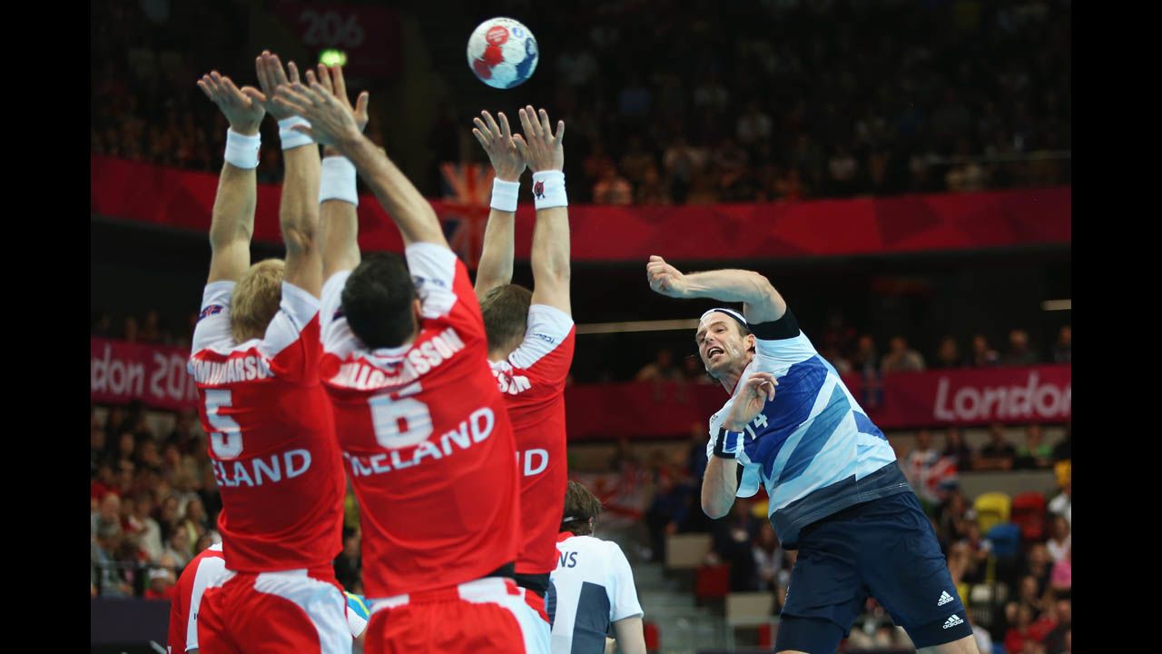 Steven Larsson of Great Britain jumps to shoot during the men's handball preliminaries Group A match against Iceland.