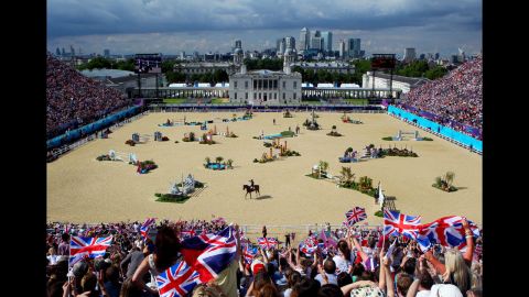 Fans cheer as Scott Brash of Great Britain, riding Hello Sanctos, finishes the third qualifier of individual jumping.