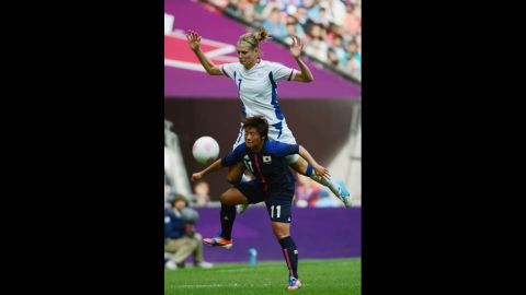 France's Corine Franco, top, vies with Japanese forward Shinobu Ohno during their semifinal match.