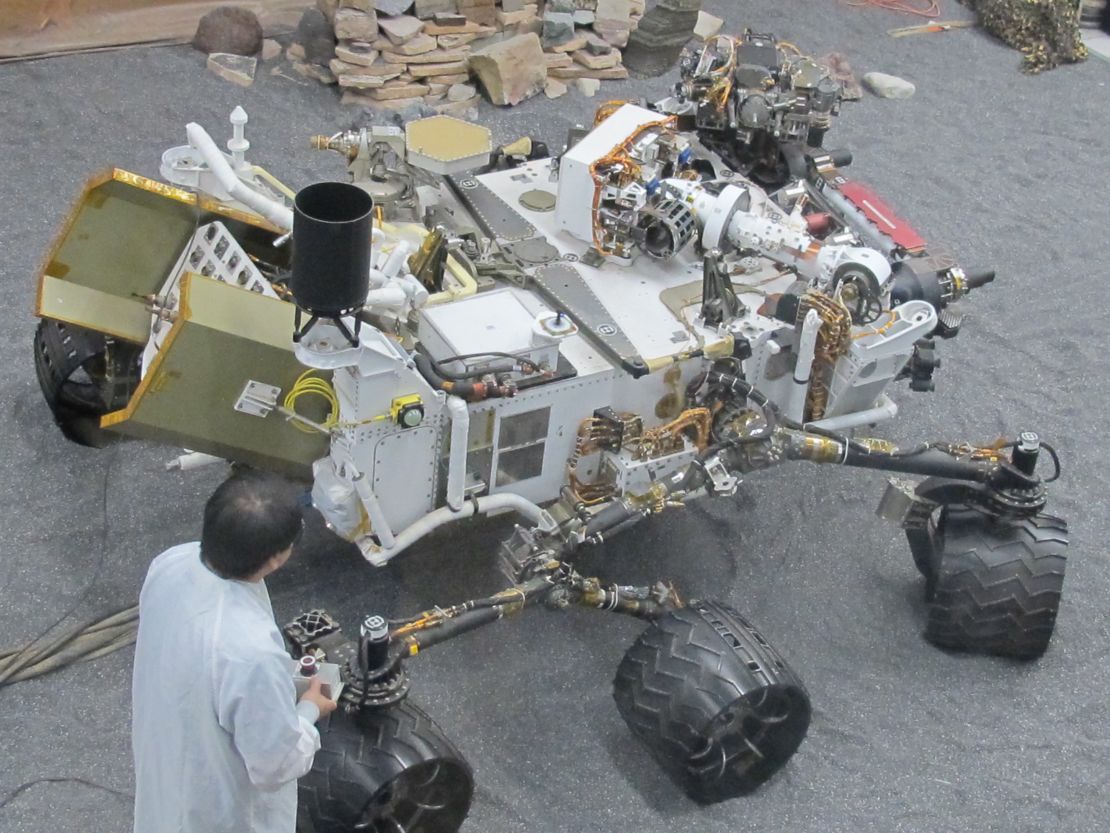 James Wang, test conductor for Curiosity, with the test model of the rover used for experiments on Earth.