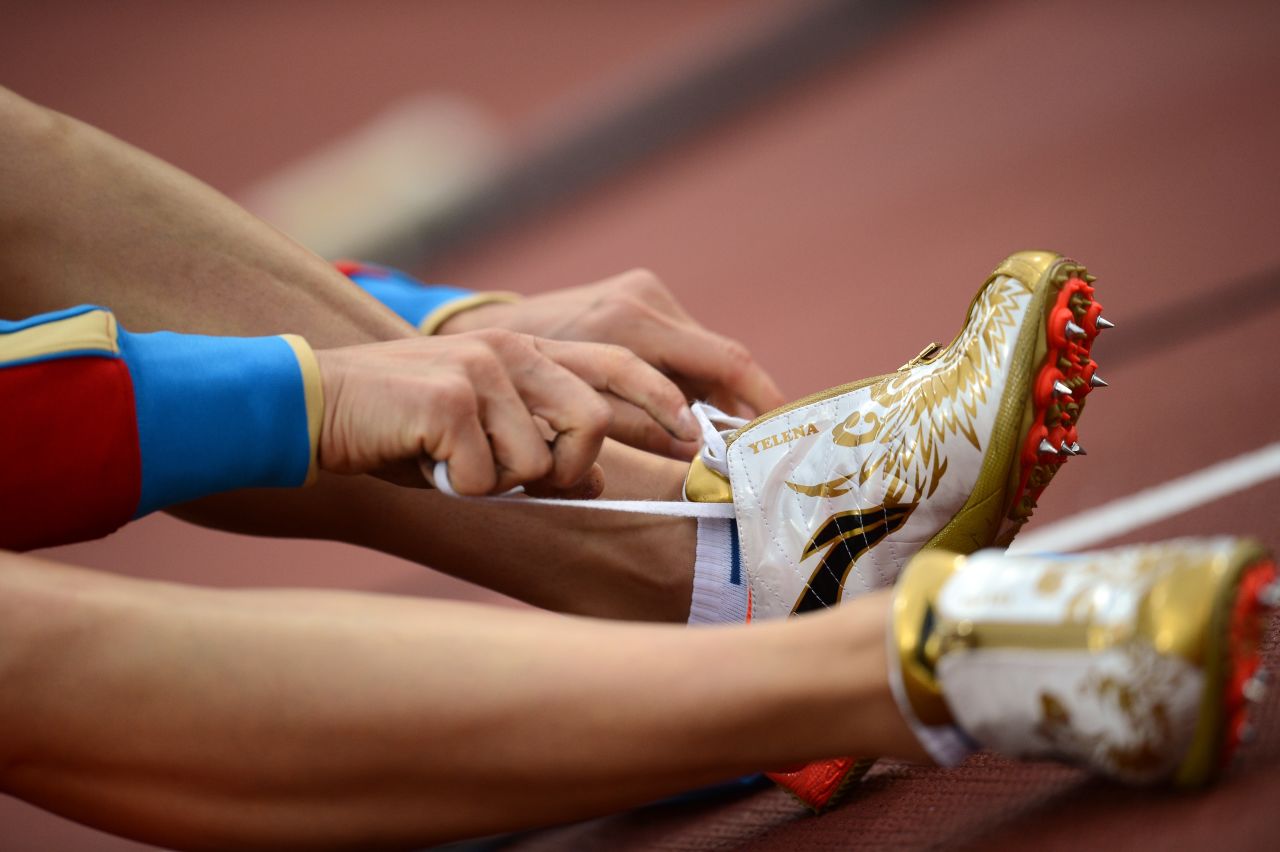 Russia's Yelena Isinbayeva laces her shoe before competing in the women's pole vault final.