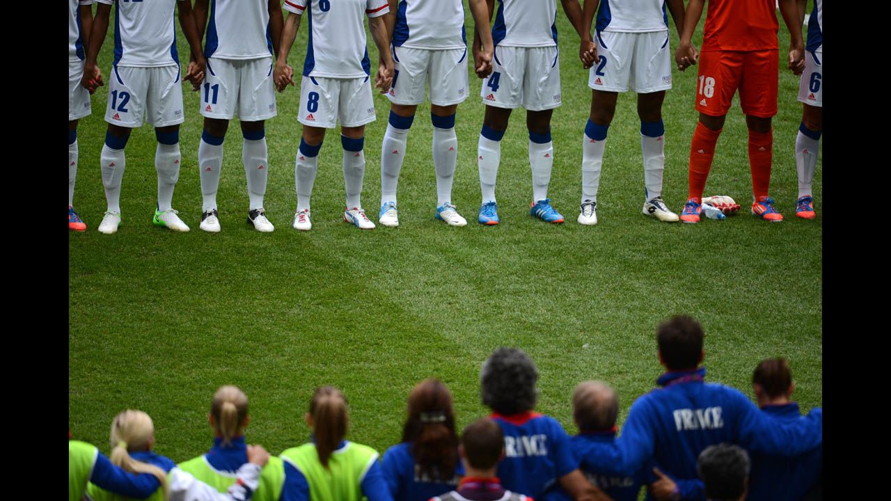 France and Japan stand in front of each other before the women's football semifinal.