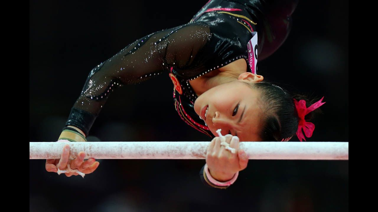 Kexin He of China competes in the artistic gymnastics women's uneven bars final.