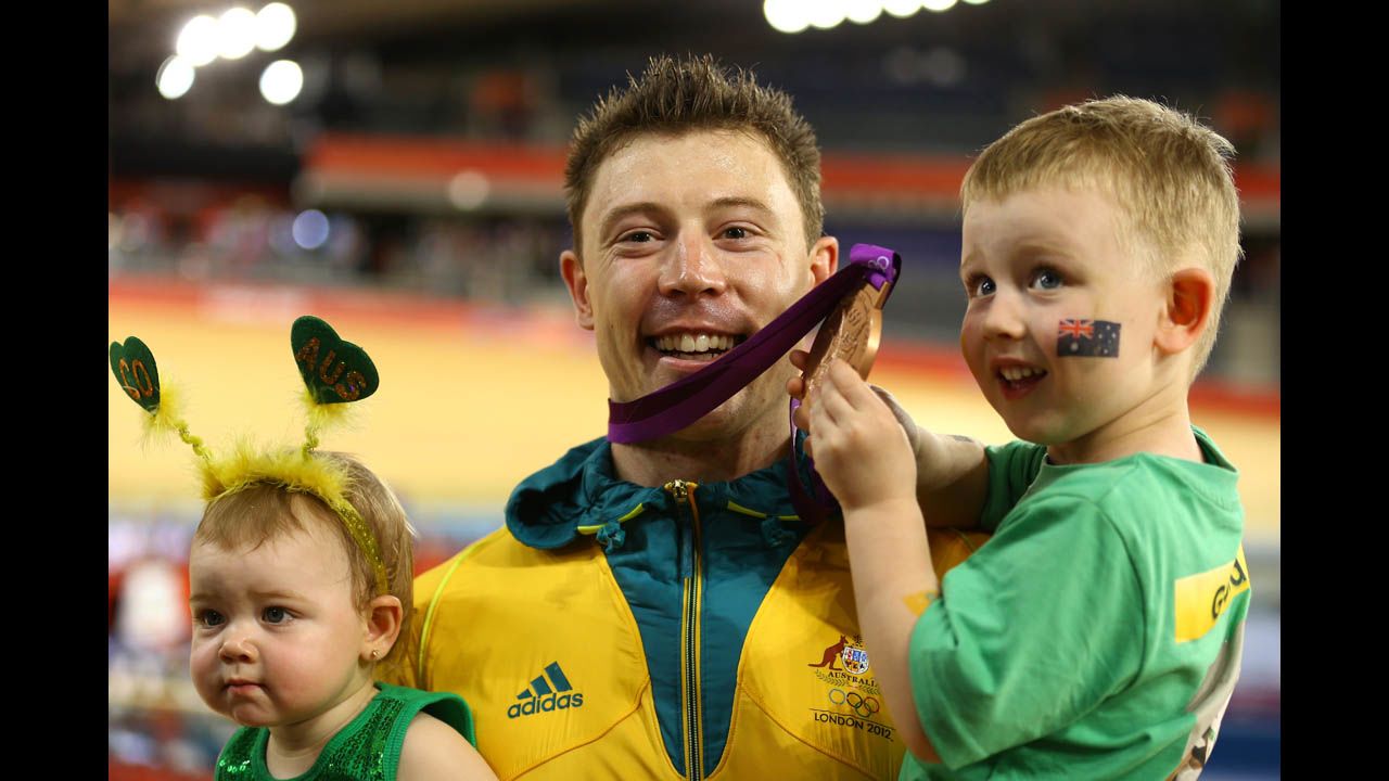 Bronze medallist Shane Perkins of Australia celebrates with his family after the medal ceremony for the men's sprint track cycling final.