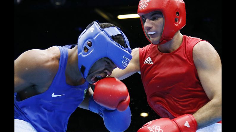 Esquiva Falcao Florentino of Brazil, left, takes a hit from Zoltan Harcsa of Hungary during the middleweight 75-kilogram boxing quarterfinals.