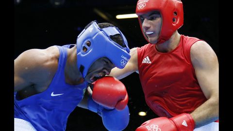 Esquiva Falcao Florentino of Brazil, left, takes a hit from Zoltan Harcsa of Hungary during the middleweight 75-kilogram boxing quarterfinals.