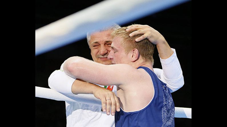 Evaldas Petrauskas of Lithuania is greeted by his corner after his victory over Domenico Valentino of Italy in the lightweight 60-kilogram boxing quarterfinals.