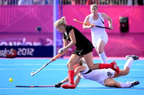 Kristina Hillmann, in black, of Germany challenges Charlotte Harrison of New Zealand during the women's field hockey preliminary round match at the Riverbank Arena on Monday.