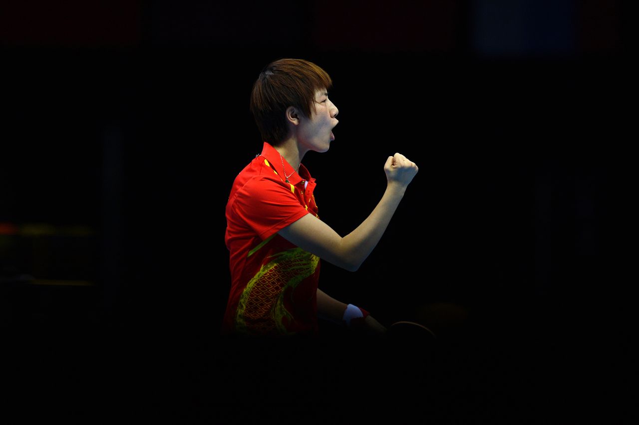 China's Ding Ning celebrates after winning a point against South Korea's Kim Kyung-Ah in the women's table tennis semifinal.