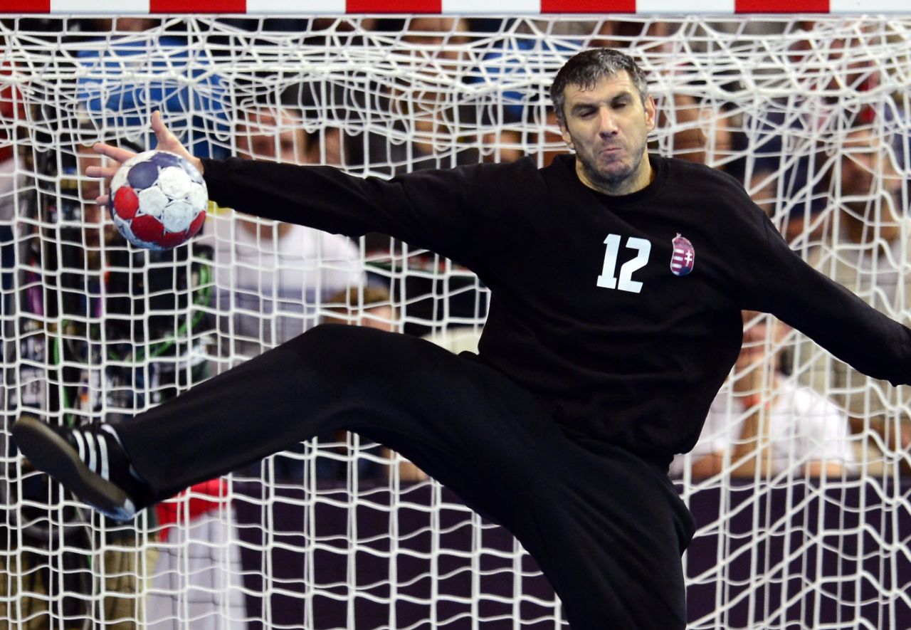 Hungarian goalkeeper Nandor Fazekas tries to block a shot from a Serbian player during the men's preliminary Group B handball match at the Copper Box hall in London.