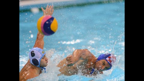 Croatia's Miho Boskovic, right, challenges Kazakhstan's Alexey Shmider during the men's water polo preliminary round Group A match.