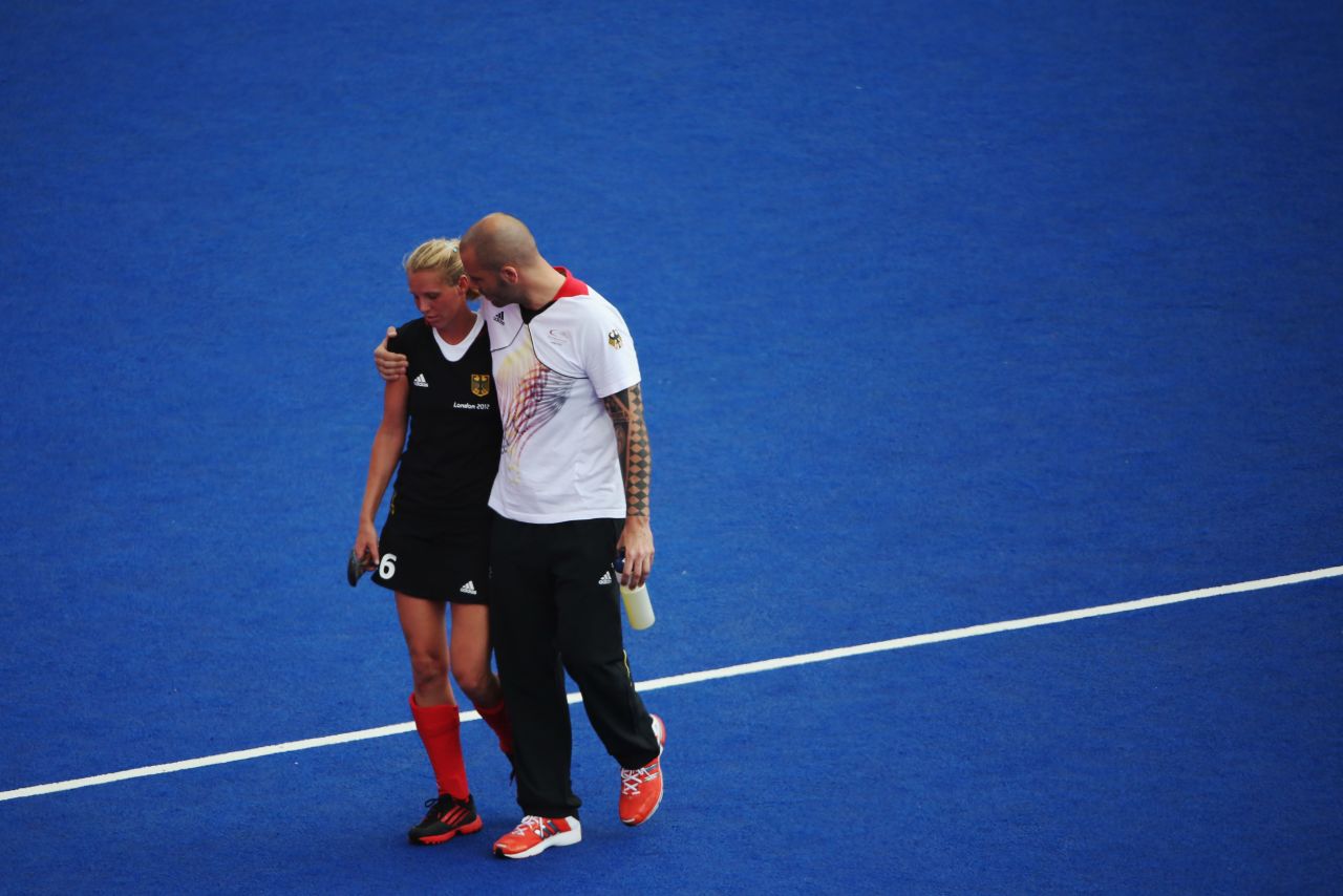Fanny Rinne of Germany is consoled as she walks off the field after the women's field hockey match with New Zealand ended in a draw.