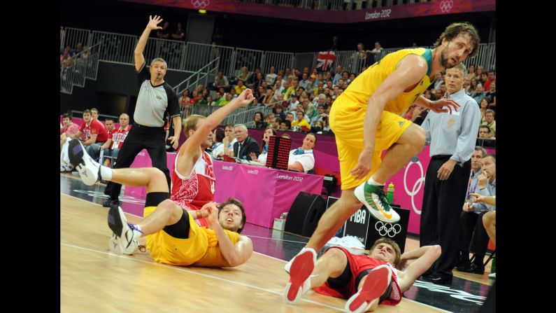 Australian, in yellow, and Russian players collide during the men's basketball preliminary round match. Check out photos of <a href="index.php?page=&url=http%3A%2F%2Fwww.cnn.com%2F2012%2F08%2F07%2Fworldsport%2Fgallery%2Folympics-day-eleven%2Findex.html" target="_blank">Day 11 of the competition</a> from Tuesday, August 7.