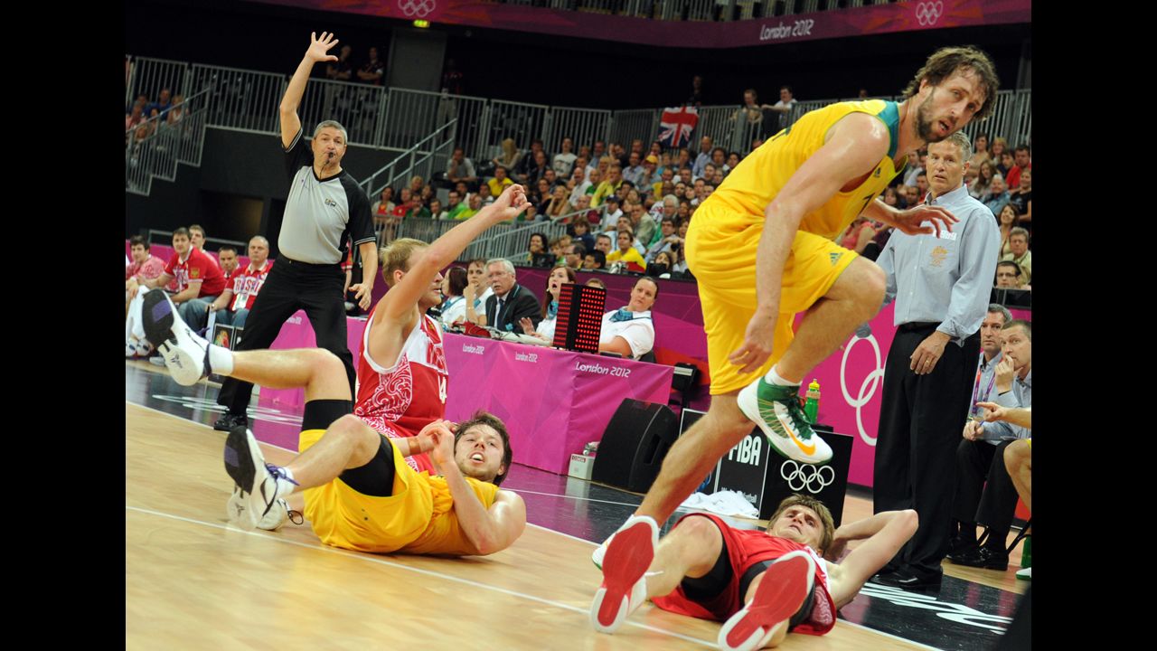 Australian, in yellow, and Russian players collide during the men's basketball preliminary round match. Check out photos of <a href="http://www.cnn.com/2012/08/07/worldsport/gallery/olympics-day-eleven/index.html" target="_blank">Day 11 of the competition</a> from Tuesday, August 7.