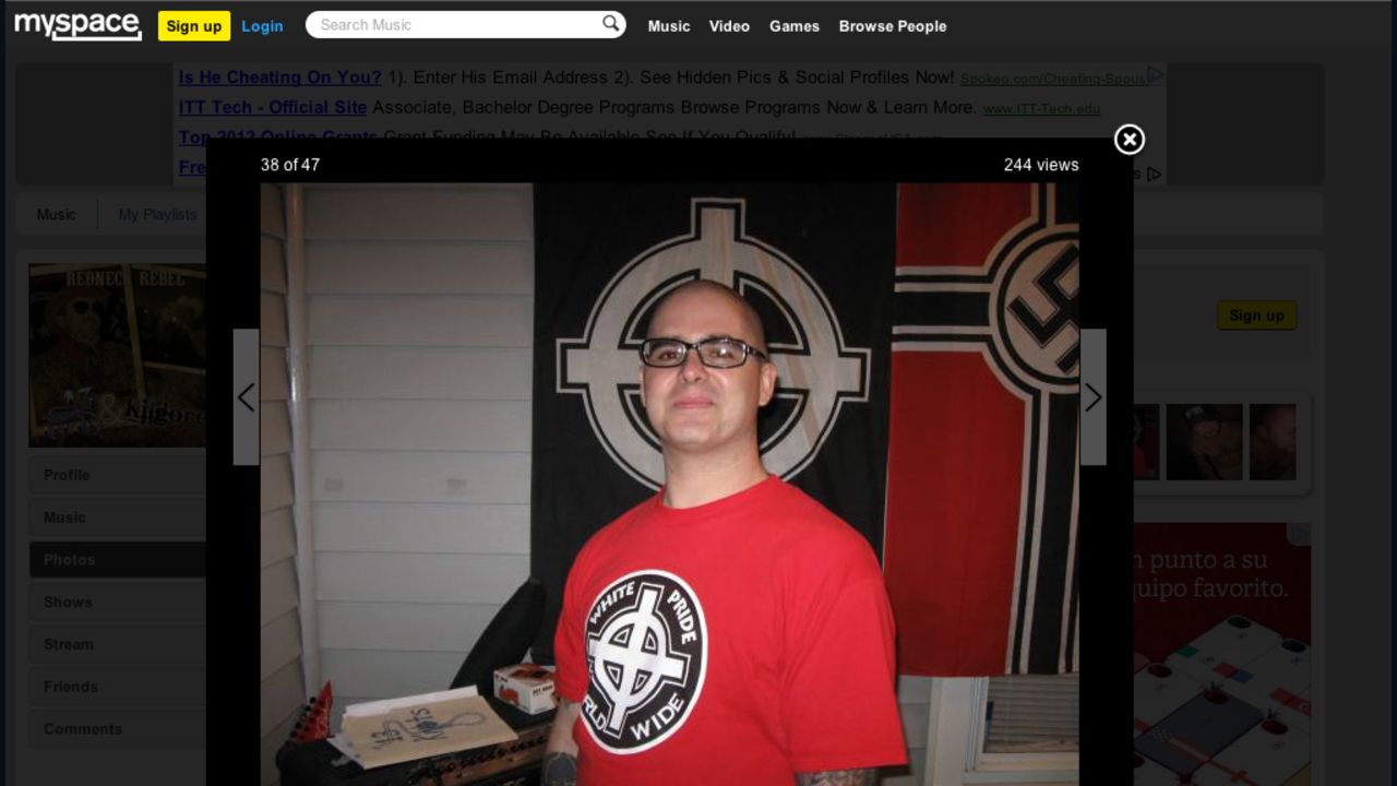 Wade Michael Page wears a white power T-shirt in front of white power and Nazi flags on a Myspace page.