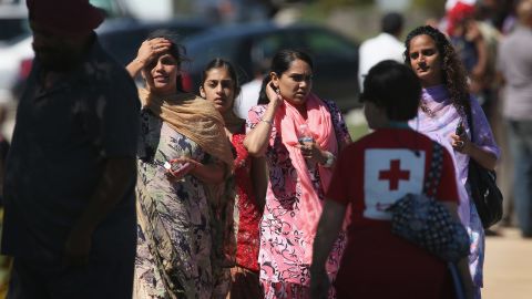 People gather outside a Sikh temple in Oak Creek, Wisconsin, where a gunman killed six people Sunday.