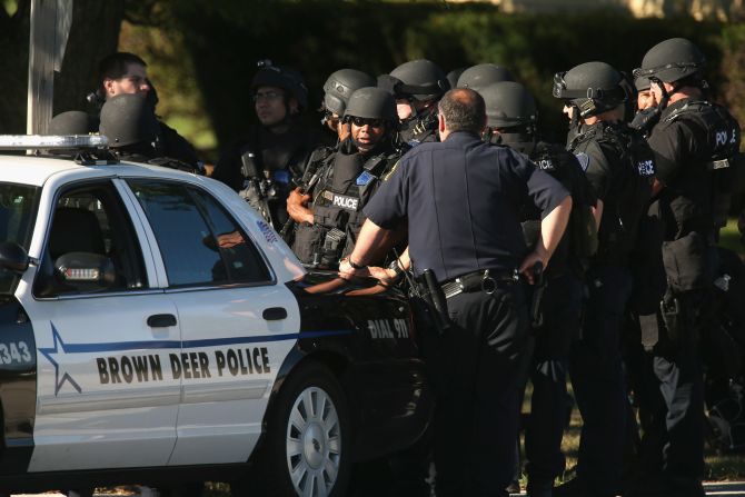 Police coordinate outside the Sikh Temple of Wisconsin, where the rampage took place.