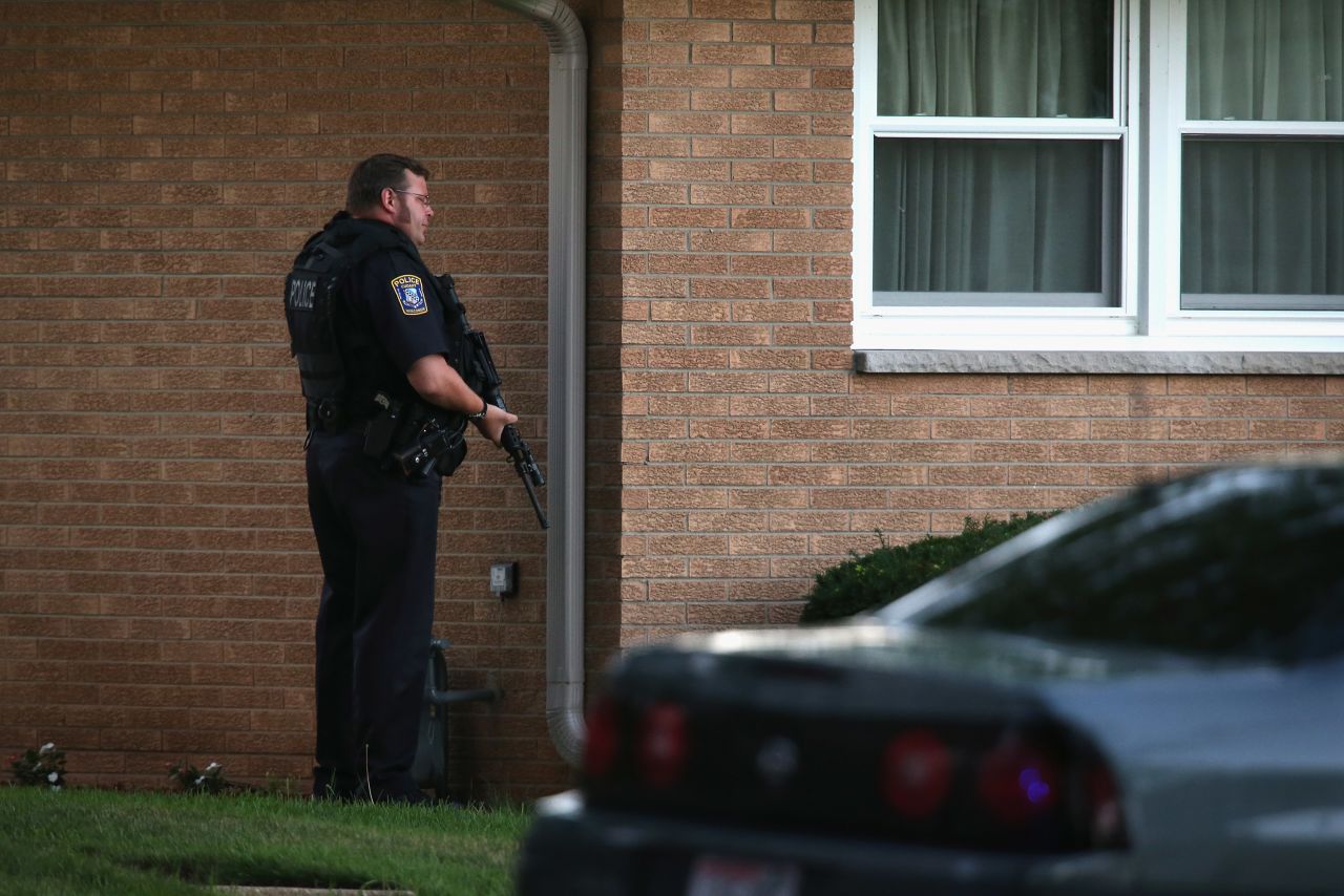 An officer works to secure a neighborhood in Cudahy, Wisconsin, on Sunday.