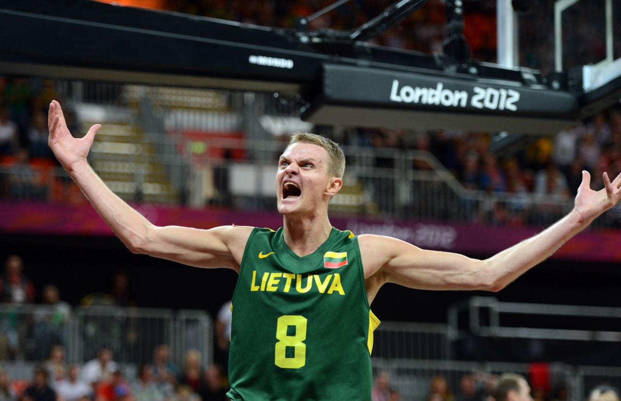 Lithuanian guard Renaldas Seibutis celebrates after scoring during the men's basketball preliminary round game against Tunisia.