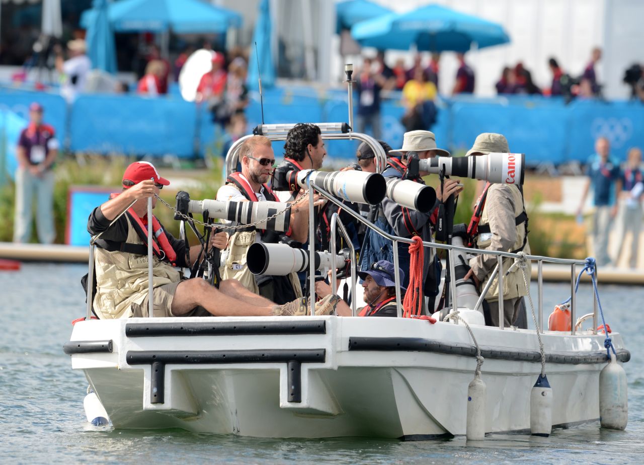 Photographers stake out on a boat for the canoe and kayak sprint.
