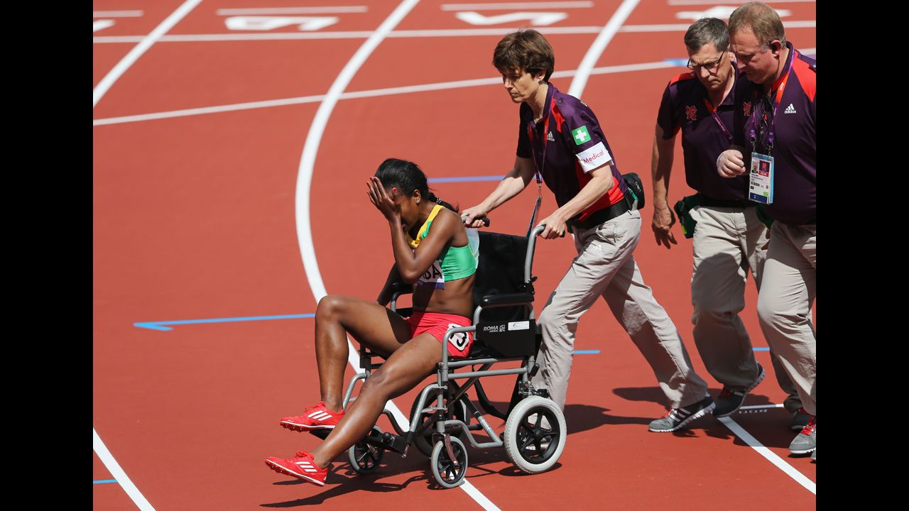 Genzebe Dibaba of Ethiopia is taken off the track in a wheelchair after competing in the women's 1,500-meter heat.