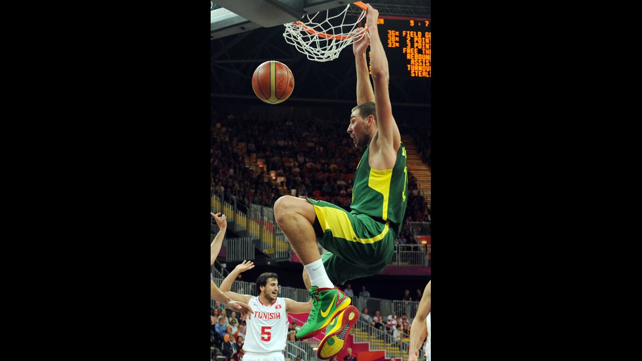 Lithuanian guard Sarunas Jasikevicius scores during the men's basketball preliminary round match against Tunisia.