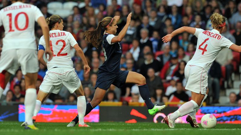 U.S. forward Alex Morgan, center in blue, runs with the ball past Canada's defender Lauren Sesselmann, number 10,  forward Christine Sinclair, number 12, and defender Carmelina Moscato, number four, during the women's soccer semifinal match on Day 10 of the London Olympic Games on Saturday, August 4.  Check out <a href="index.php?page=&url=http%3A%2F%2Fwww.cnn.com%2F2012%2F08%2F05%2Fworldsport%2Fgallery%2Folympics-day-9%2Findex.html" target="_blank">Day 9 of competition</a> from Sunday, August 5. 