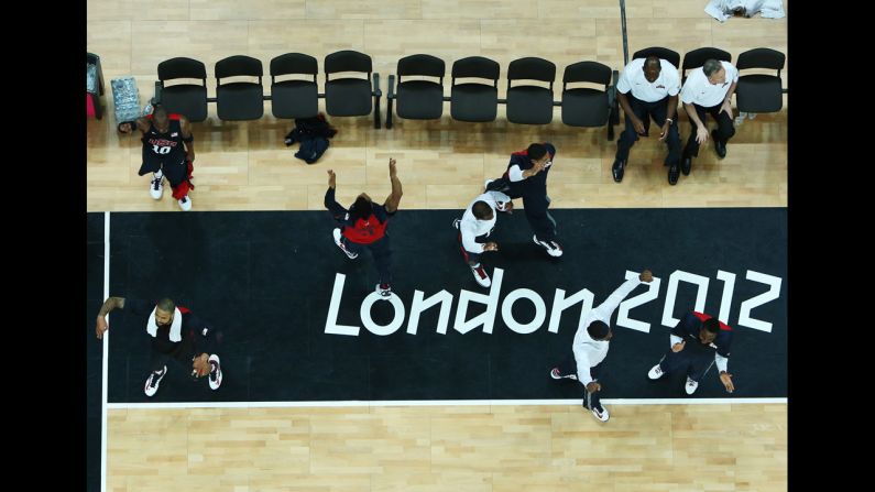 The U.S. men's basketball team reacts to defeating Argentina during a preliminary round match.