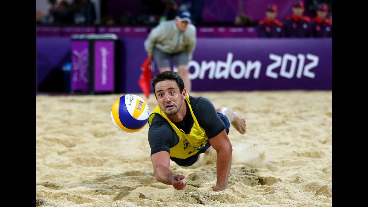 Pedro Cunha of Brazil reaches to hit a return against the German team during the men's beach volleyball quarterfinal.