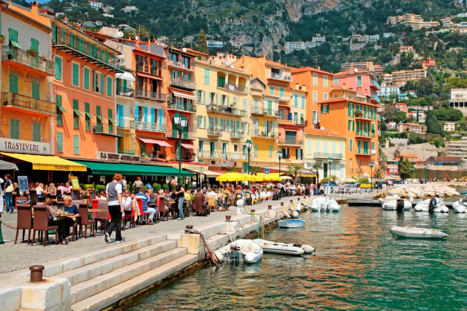 Colorful buildings provide a sun-splashed backdrop for restaurants along Villefranche-sur-Mer's lively quai. The Côte d'Azur's mild climate allows for outdoor dining and aperitif sipping most of the year.