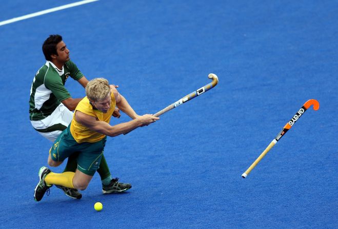 Shafqat Easool of Pakistan, left, fouls Matthew Butturini of Australia during a men's hockey preliminary match.