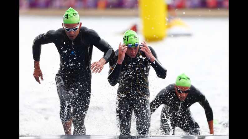 Felipe van de Wyngard of Chile, left, and Brendan Sexton of Australia swim in the men's triathlon at Hyde Park in London.