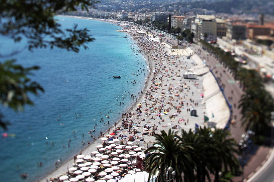 Sunbathers gather en masse during the summer on the beach along Nice's Promenade des Anglais, a wide boulevard and pedestrian walkway along the Mediterranean Sea.