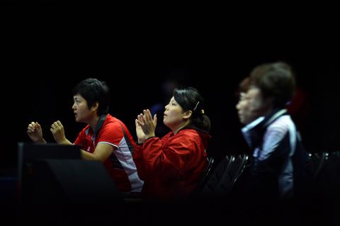 Singapore's team members celebrate a point made by Feng Tianwei against South Korea's Kim Kyungah during the women's team table tennis bronze medal match.