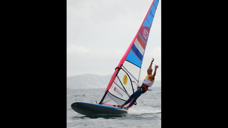 Dorian van Rijsselberge of the Netherlands celebrates after winning the gold medal in the men's RS-X class race in Weymouth, England.