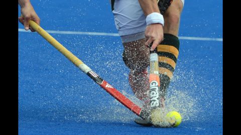 Argentine hockey player Juan Martin Lopez, left, and Lloyd Norris-Jones of South Africa spar for the ball during a field hockey preliminary match.