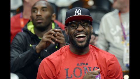U.S. forward LeBron James, front, and guard Kobe Bryant attend the U.S. women's quarterfinal basketball game against Canada.