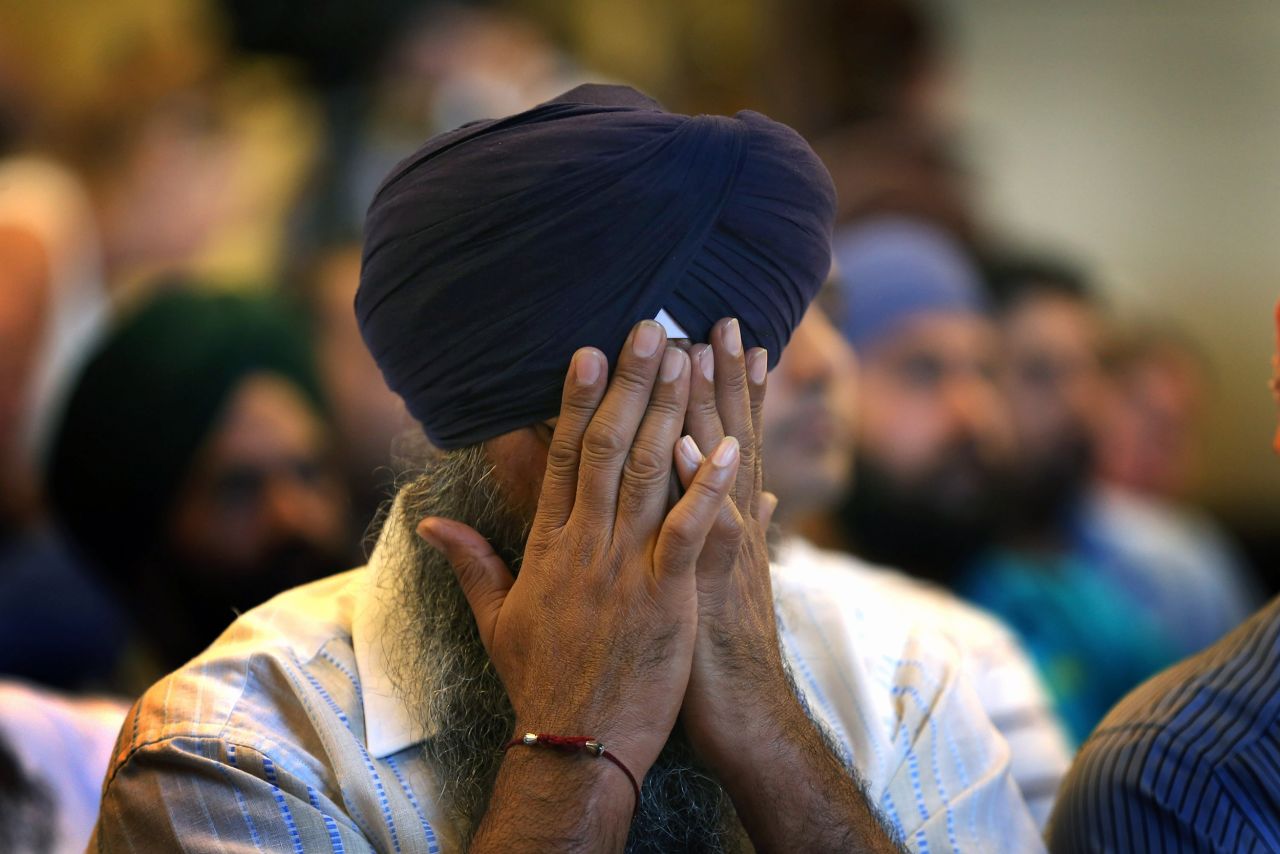 A member of the Miwaukee-area Sikh community weeps as he listens to information about the shooting spree.